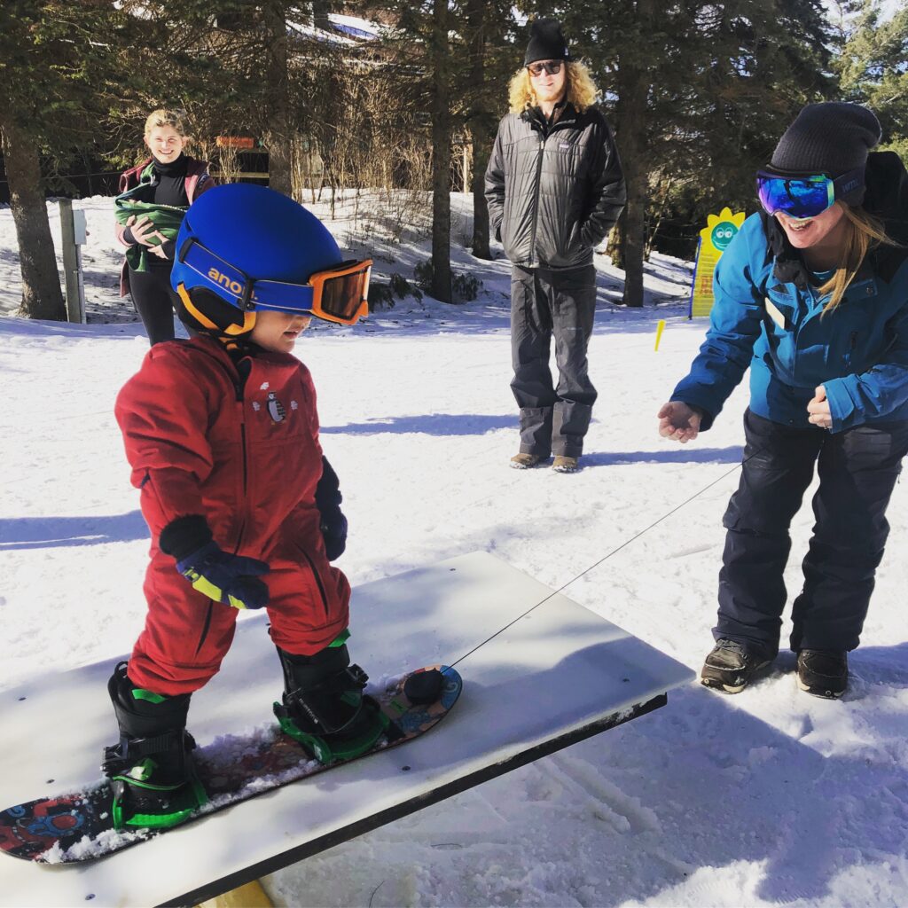 Toddler learning to snowboard at Smugglers' Notch 