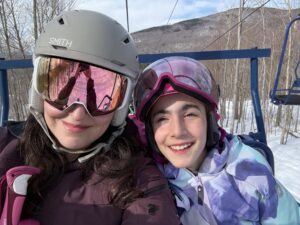 Mom and daughter on ski lift at Smuggs